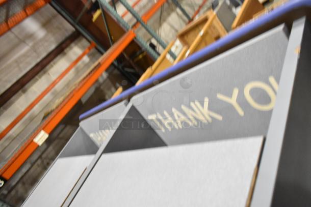 Pair of gray double trash can shells on casters, with "Thank You" printed. Used, good condition. Auction 2x your bid.