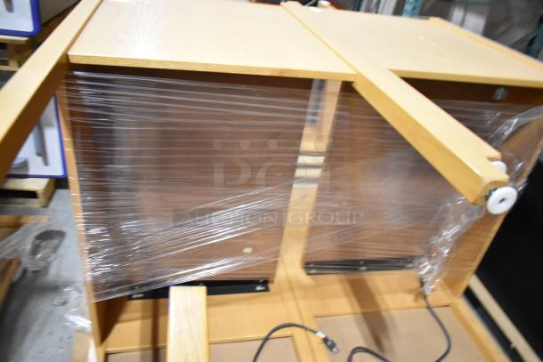 Two wood pattern desks, wrapped in plastic. Good condition, sturdy design. Includes cable openings and adjustable feet.