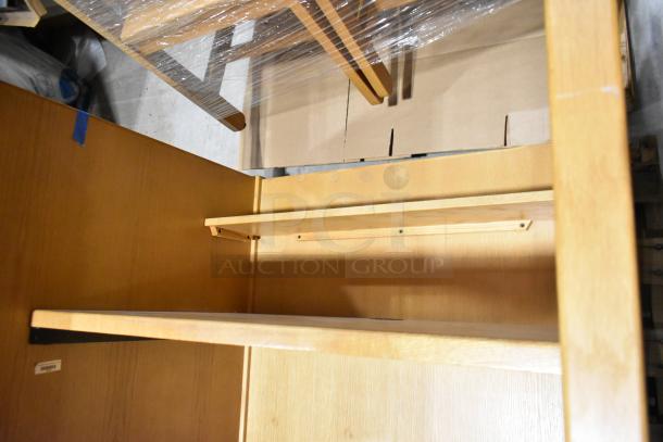 Wood pattern desk in light finish, medium size. Features include a shelf and sturdy construction. Slight scratches visible.