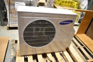 Samsung UD26A1C2 metal air conditioner, 208-230V, 1 phase, 12,500-13,500 BTU, in good condition, shown on a pallet.