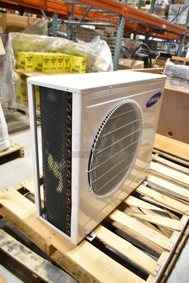 Samsung UD26A1C2 metal air conditioner, 208-230 volts, 1 phase, 12,500-13,500 BTU, in good condition on a pallet.