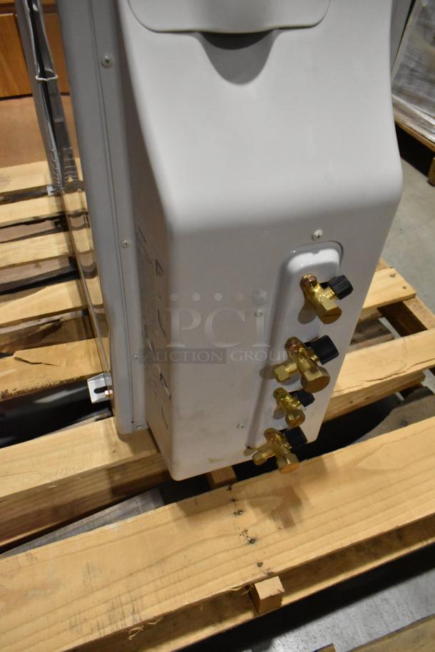 Samsung UD26A1C2 metal air conditioner on wooden pallet, showing valve connections. 208-230 Volts, 1 Phase, 12,500-13,500 BTU.