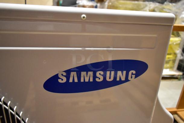 Samsung UD26A1C2 air conditioner, metal casing, 208-230V, 1 phase, 12,500-13,500 BTU, visible logo.