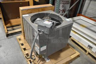 Rheem 13PJA24A01 metal air conditioner condenser. 208/230 volts, 1 phase. Appears in good condition. Features visible labeling.