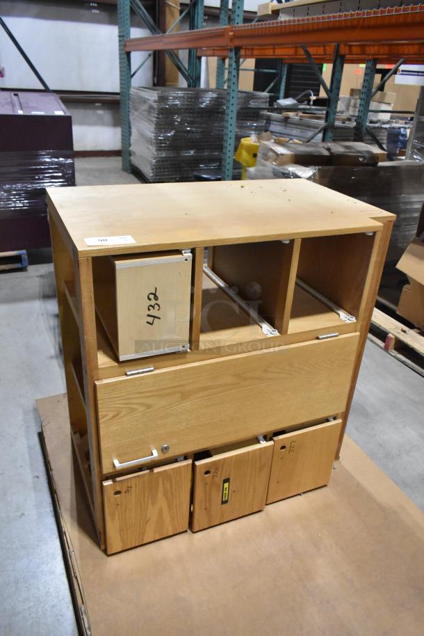 Wood pattern cabinet with door and 4 drawers, medium wood finish, used condition, labels with numbers visible.