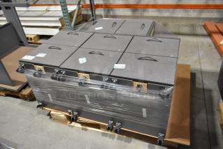 Four gray 2-drawer filing cabinets on casters, stacked and wrapped in plastic. Each drawer has a handle and label slot. Condition appears new.
