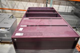 Two maroon metal cabinets, one with two drawers, shown in a warehouse setting. Visible labels indicate auction lot number.