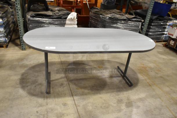 Gray oval table with metal legs, clean condition, suitable for office or home use, minor wear visible, labeled "94".