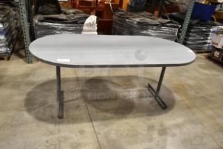 Gray oval table with metal legs, clean condition, suitable for office or home use, minor wear visible, labeled "94".