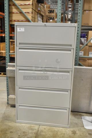 Gray metal filing cabinet with 4 drawers and 1 door, in good condition. Auction Lot 96 tag visible.