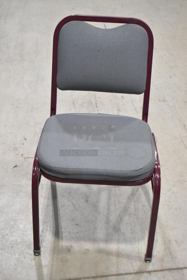Maroon metal chair with gray padded seat and backrest, sturdy frame, sold in a lot of 22. Ideal for events or venues.