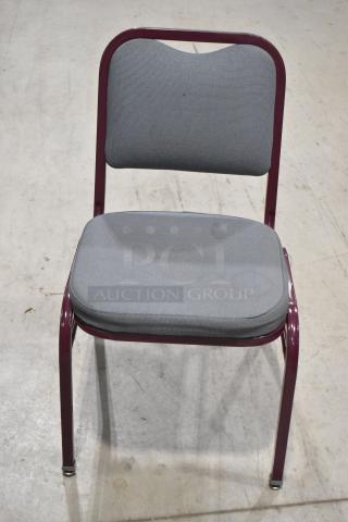 Maroon metal chair with gray padded seat and backrest, sturdy frame, sold in a lot of 22. Ideal for events or venues.
