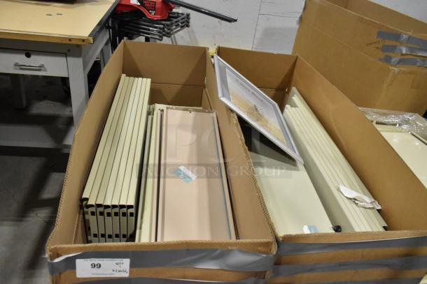 Three pallets of assorted metal panels in cardboard boxes. Panels appear unused. Tags display "99 QTY X 2 Pallet."