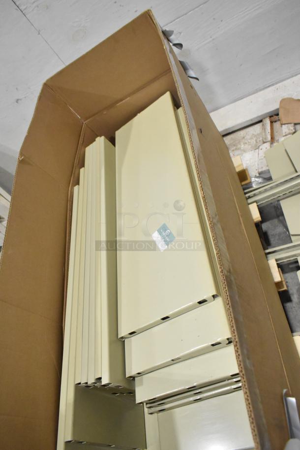 3 pallets of beige metal panels in cardboard box, featuring slotted edges. Panels appear in excellent condition.