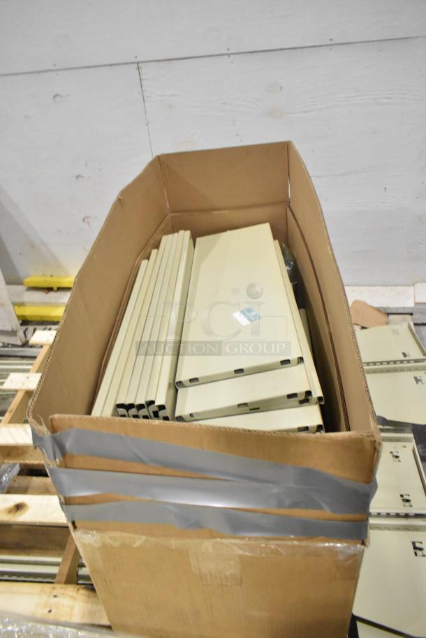 3 pallets of beige metal panels in a cardboard box, suitable for construction projects, some with factory labels.