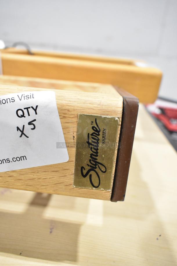 5 Signature Series wooden tables with electronics, label reads "QTY x5". Polished finish, branded with Signature Series plaque.