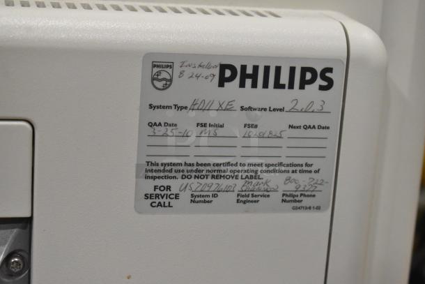 Philips HD11XE Ultrasound System label showing system type, QAA date, software level, service info, and installation date.