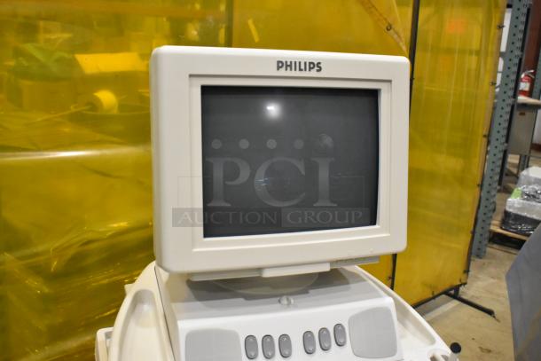 Philips M2540A ultrasound system with monitor, buttons, and control panel. Mounted on casters. Condition appears good.