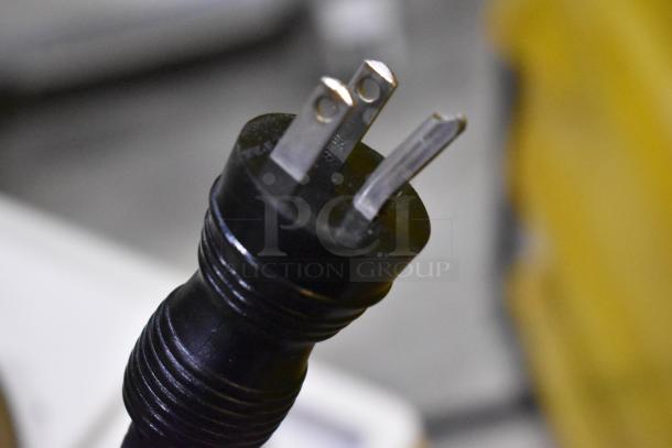 Close-up of a three-prong power plug from a Philips M2540A Ultrasound System, highlighting its condition and detail.