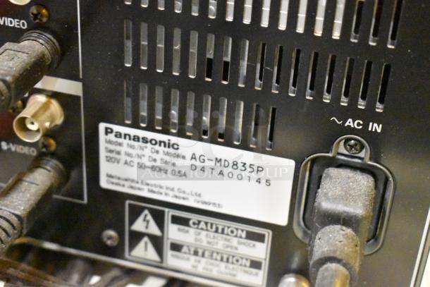 Panasonic AG-MD835P model label on back panel, showing serial number D4TA00145, AC input details, and caution warning.