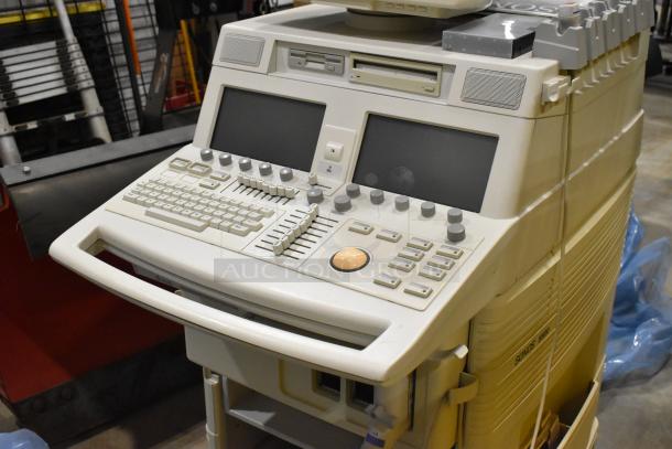 Philips M2424A ultrasound system on casters, features dual screens, control panel with knobs and buttons, in used condition.
