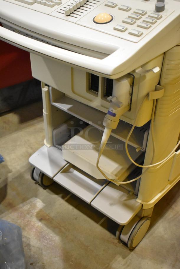 Philips M2424A Ultrasound System on casters, showing control panel, probes, and storage shelves. Good condition.