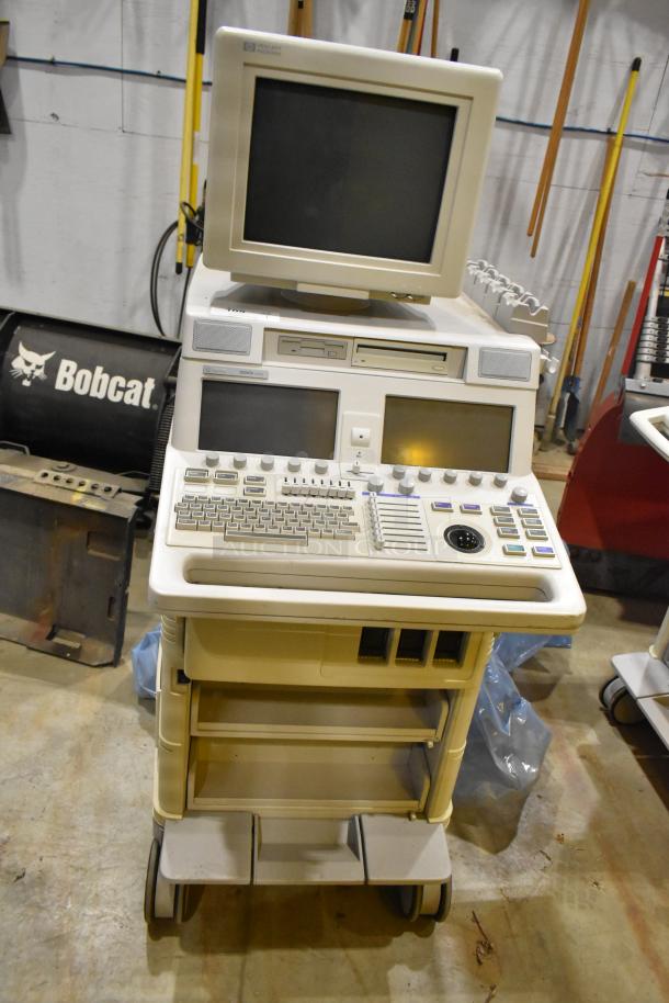 Hewlett Packard HP Ultrasound System on casters, featuring control panel, monitor, storage shelves; used condition.