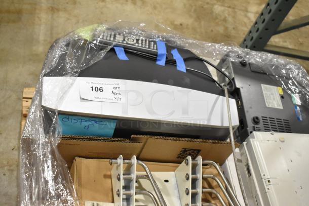 Pallet lot with Bionet CardioTouch-3000, GE Medical MAC1200 EKG Machine. Mixed medical items. Auction label visible.