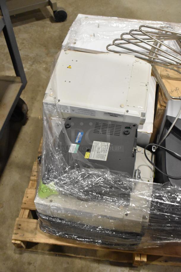 Pallet lot of medical equipment including Bionet CardioTouch-3000 ECG and GE Medical MAC1200 EKG Machine, wrapped for auction.