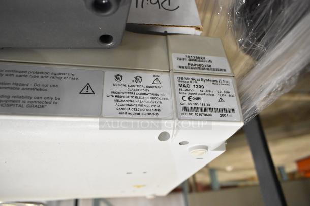 Pallet lot including Bionet CardioTouch-3000 ECG and GE Medical MAC1200 EKG machine, labeled for medical use, model details visible.