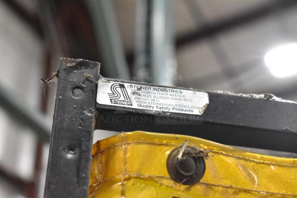 Steiner Industries screen with a safety label, visible wear, yellow material, part of auction for two screens.