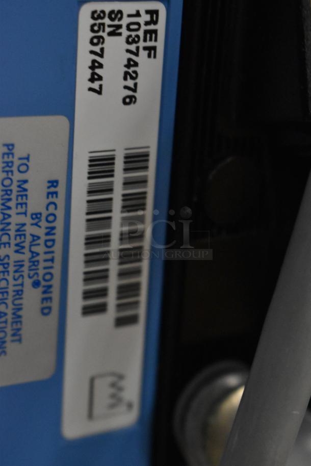 Reconditioned Alaris infusion system label with reference number 10874276 and serial number 3567447.