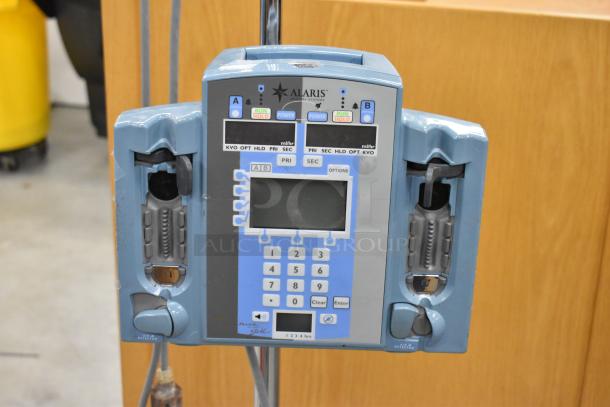 Alaris Signature Edition Infusion System, on casters, features dual channels, digital display, in used condition.