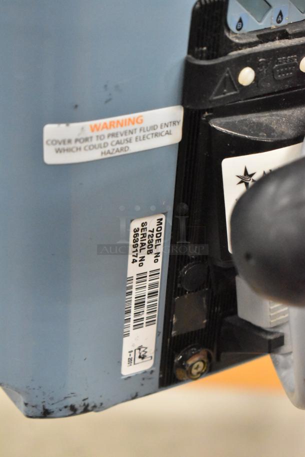 Alaris Signature Edition Infusion System, Model 7230B, visible label with model and serial number, warning label present.