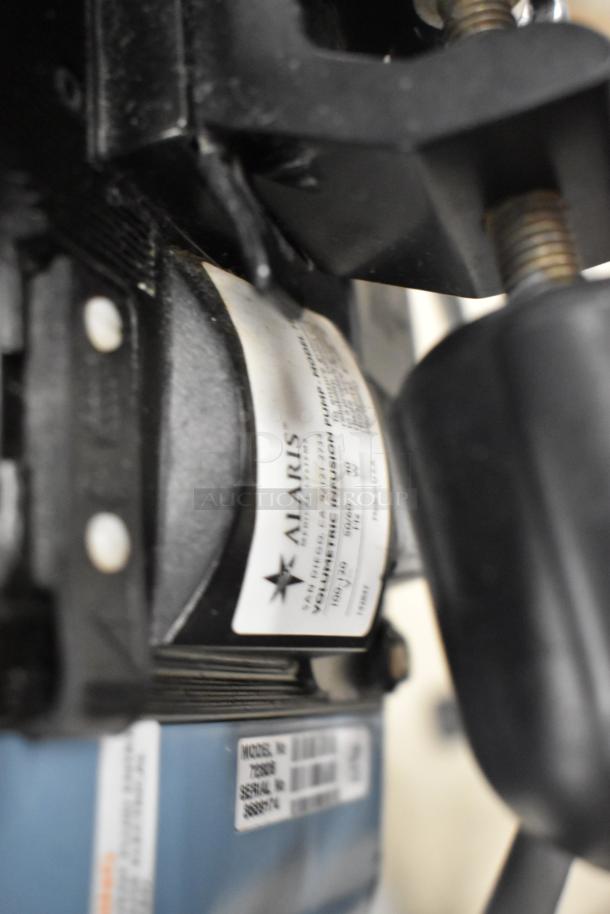 Close-up of an Alaris Signature Edition infusion system label, showing model and serial numbers, indicating professional medical equipment.