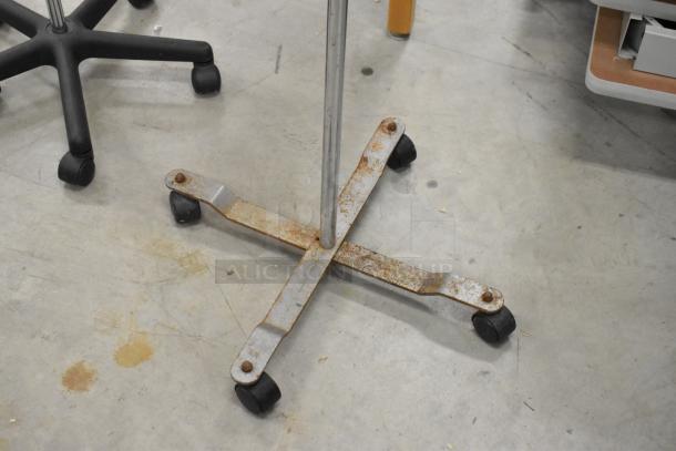 Three items include two Alaris Signature Edition Infusion Systems and one stand, all on casters. Rust visible on metal base.