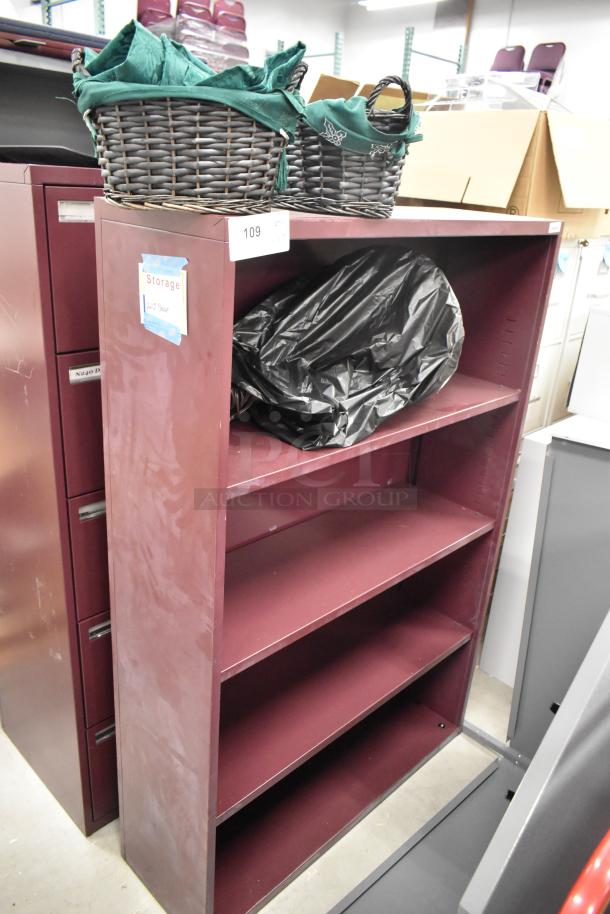 Maroon metal book shelf and 5-drawer filing cabinet. Includes storage baskets. Slight wear visible.