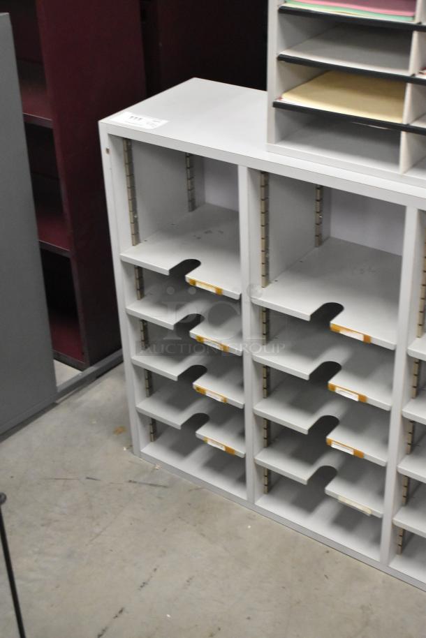 Gray countertop multi cubby mailboxes with multiple slots, used condition, ideal for organizing mail or documents.