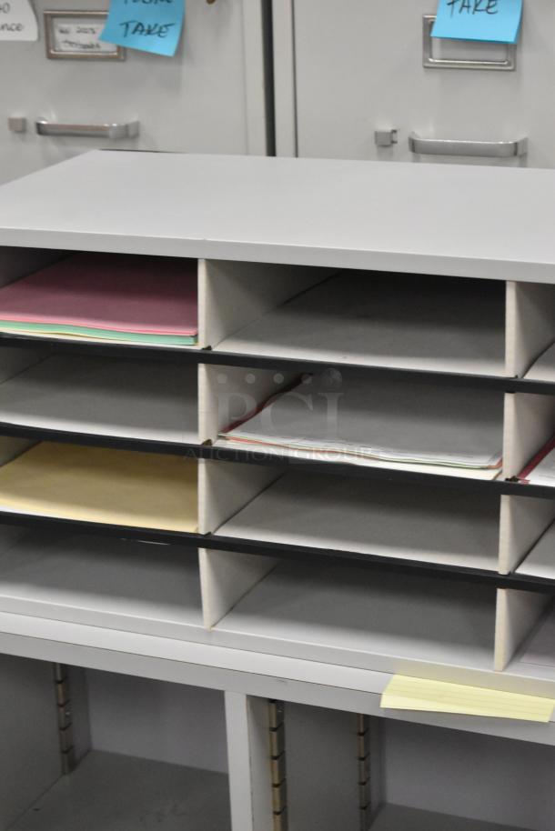 Two countertop multi-cubby mailboxes with multiple compartments, gray and black finish, used for organizing mail or documents.