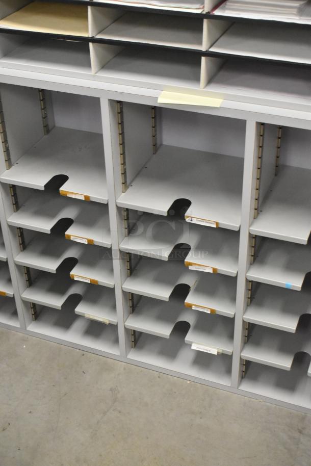 Gray countertop multi cubby mailboxes with multiple slots and labeling areas. Good condition. Two units available.