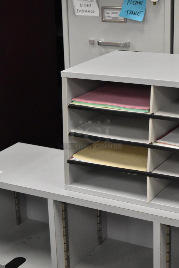 2 countertop multi cubby mailboxes with multiple compartments, white finish, used condition, visible documents inside.