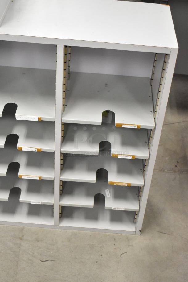 2 countertop multi cubby mailboxes, white, multiple shelves, good condition, name labels on edges, suitable for office use.