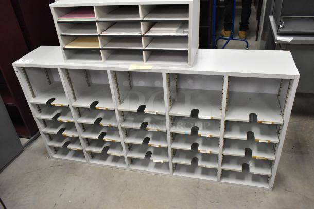 Two gray countertop multi-cubby mailboxes, each with multiple slots. Ideal for organizing documents. Good condition.