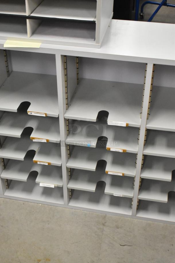 2 countertop multi cubby mailboxes, gray with multiple slots, labels visible, in good condition for auction.