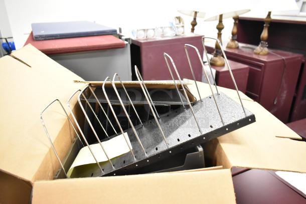 Cardboard box containing a metal file rack, staplers, and assorted office items; labeled "3 Times Your Bid."