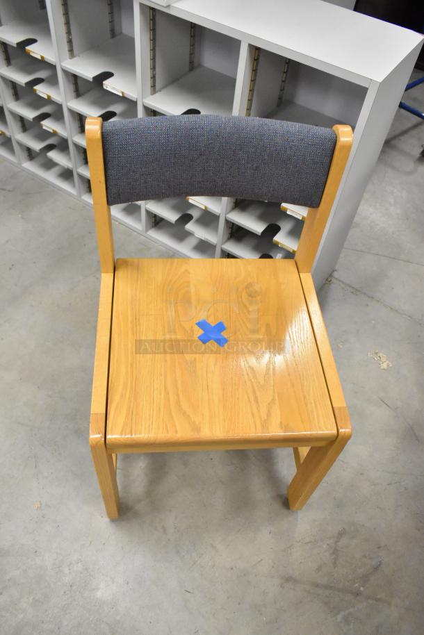 Wood pattern chair with upholstered backrest, light wood finish, minor wear shown by blue tape marking.