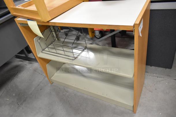 Wooden book shelf with two shelves and metal basket, moderate wear, auction tag attached, versatile storage solution.