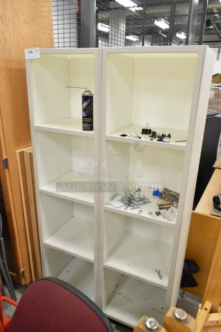 8 cubby shelving unit, white, displays light wear. Contains various small items. Auction tag 116 visible on corner.