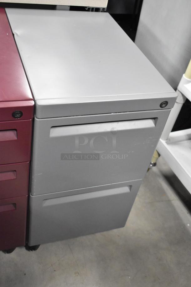 Four filing cabinets on casters: 3-drawer maroon and 2-drawer gray. Visible locks and handles, in good condition.