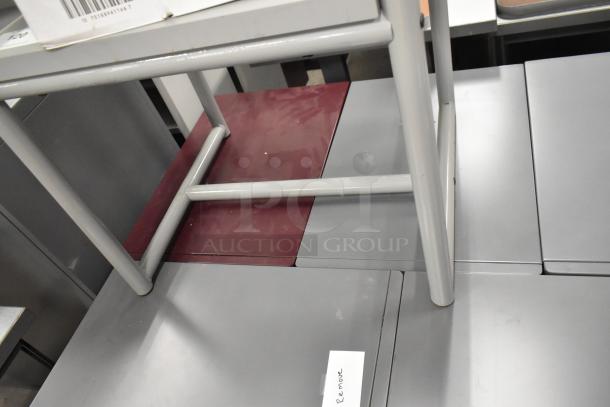 4 filing cabinets on casters: 3-drawer maroon, 2-drawer gray. Visible stacking marks and "Remove" tag on gray cabinet.